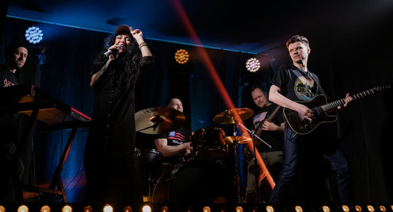 Photo of band performing on stage.